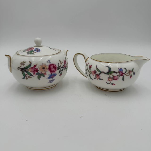 Wedgwoods Devon Sprays is a graceful dinnerware pattern accented with blue & pink flowers, long stems, and leaves. With...