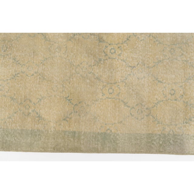 This is a vintage Turkish Oushak rug from the 1960s. The piece was hand-knotted.