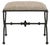 The curvaceous sides and the ornamented stretcher of the Agora Peppercorn Ottoman are made of iron in a rustic bronze...