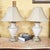 Elegant vintage Neoclassical trophy urn table lamps, made in the USA, featuring light cream crackle-glazed ceramic urns...