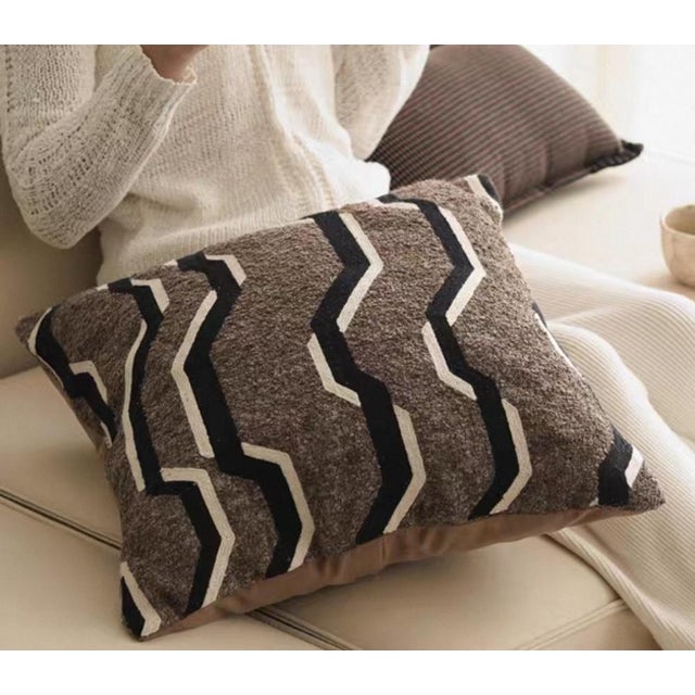 This is a 19-inch solid throw pillow filled with feather velvet and featuring a concealed zipper