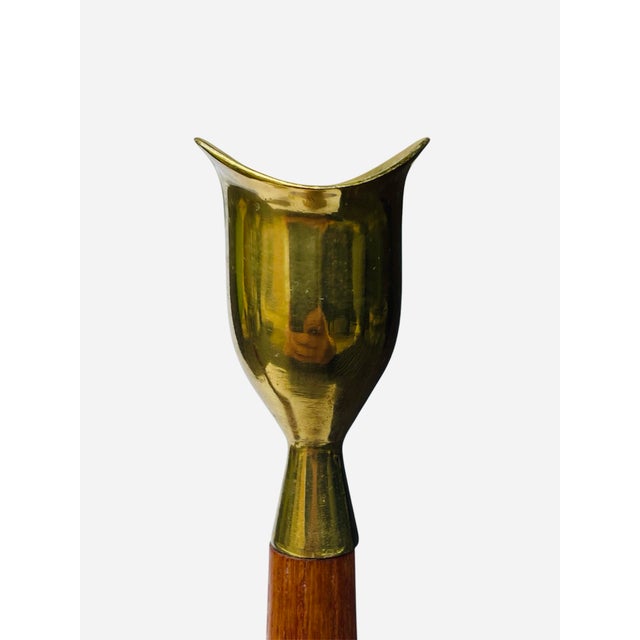 Sleek Scandinavian style teak wood and brass candleholders from the 60s. Turned wood design with sculptural brass...