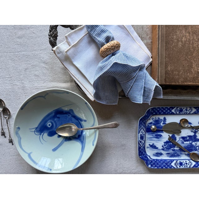 This vintage Chinese porcelain serving bowl features a boldly hand-painted koi fish motif rendered in rich royal blue...