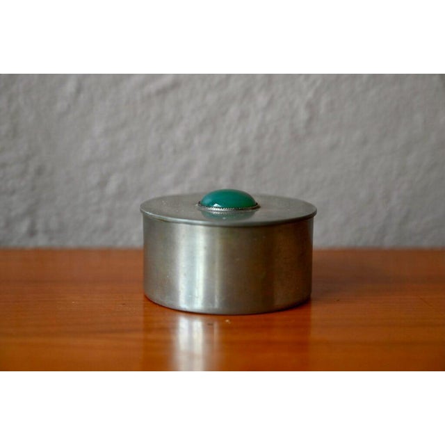 This pretty jewelry box is a Danish creation from the 1960s. Made of simple, brass-plated metal, it has a distinctive and...