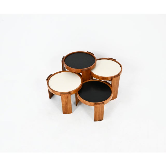Wooden nesting table. Reversible black and white top. Stamped Cassina. Wear due to time and age of the table. Measures:...
