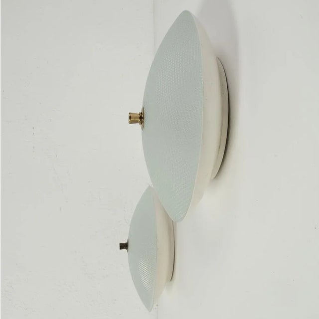 Pair of beautiful disc ceiling lights, original Italian production from the 1950s. Wall mounting base in enamelled metal,...