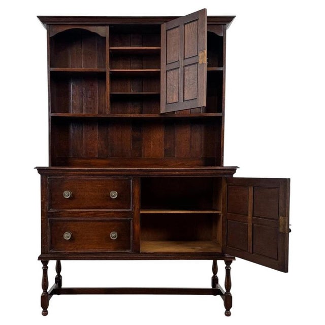A handsome early 20th-century English dresser, finely constructed from oak and combining generous display space with...
