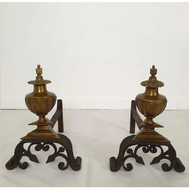 Pair of Italian decorative andirons, circa 1900s. The pair of andirons is made of bronze and hand-crafted wrought iron....