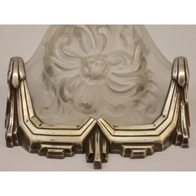 A stunning pair of French Art Deco wall sconces by the French artist " Marius Ernest SABINO " in clear and frosted molded...
