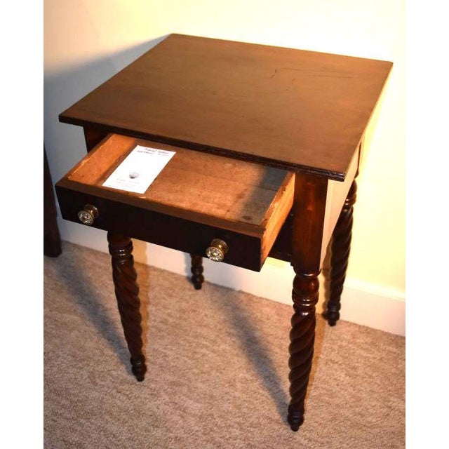 American late Sheraton two drawer night stand circa 1810 to 1820. Possibly from New York State. Composed of cherry primary...