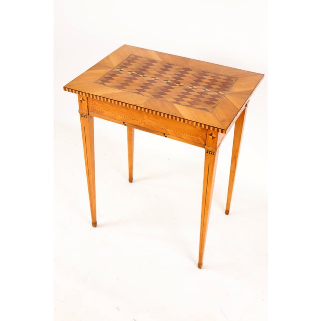 Top panel with marquetry in cherry, maple, plum and walnut, side panel with geometric inlays and continuous strapwork,...