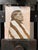 This oil painting on board features a dignified figure draped in a striped blanket, set against a vibrant yellow...