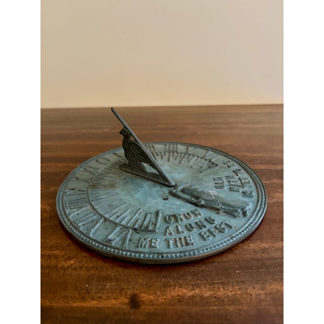 A stunning vintage iron verdigris garden sundial reading "Grow old along with me. The best is yet to be." USA, Late 20th...
