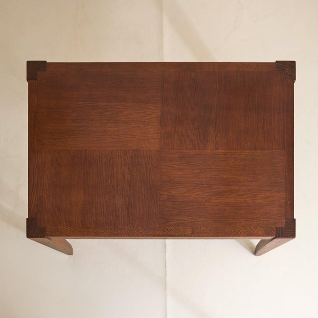 A French dining table from the mid-20th century, crafted in solid oak. Rectangular in form, the top reads as a single...