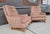 A pair of Mid-Century Modern high-back upholstered lounge chairs with exposed wood base. Appear to have an older re-...
