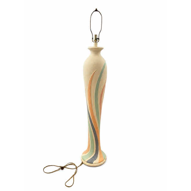 This is a vintage 1980s postmodern plaster floor lamp. It features a textured cream-white body with sweeping, hand-painted...