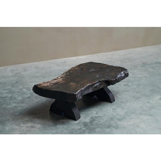 Sculptural Live Edge Coffee Table in Solid Dark Stained Wood, Europe, 1960s. An impressive and unusual piece, this dark...