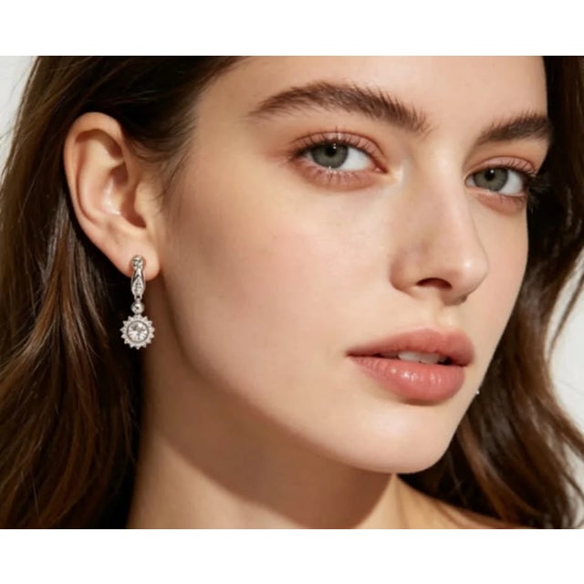 This stunning pair of 14K white gold earrings features a pave diamond sunflower design , perfect for adding elegance to...