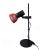 An arresting 1980s adjustable desk lamp with round enameled black base and stem, red metal shade, and power switch on the...