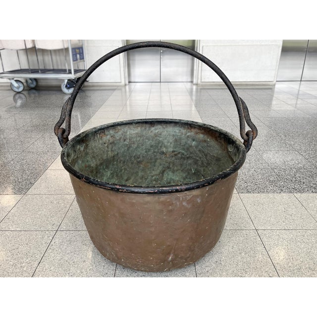This antique copper cauldron was hand-crafted in France in the 19th Century. It has a hand-forged iron handle and rounded...