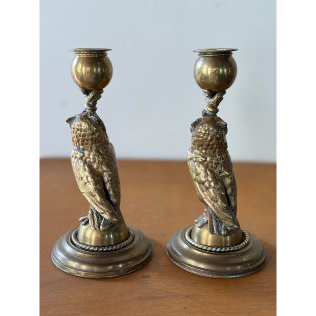 This is a pair of figural bronze owl candlesticks with glass eyes, each clutching a snake it its mouth. Beautifully cast...