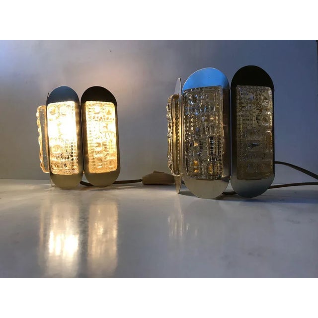 These Sconces was manufactured by Vitrika and designed in Denmark in the 1960s. This Model is made from brass-alloy...