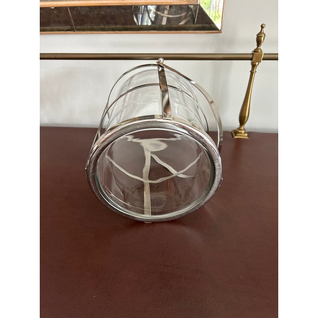 This versatile silver-tone metal and glass piece works beautifully as an ice bucket, hurricane candle holder, or...