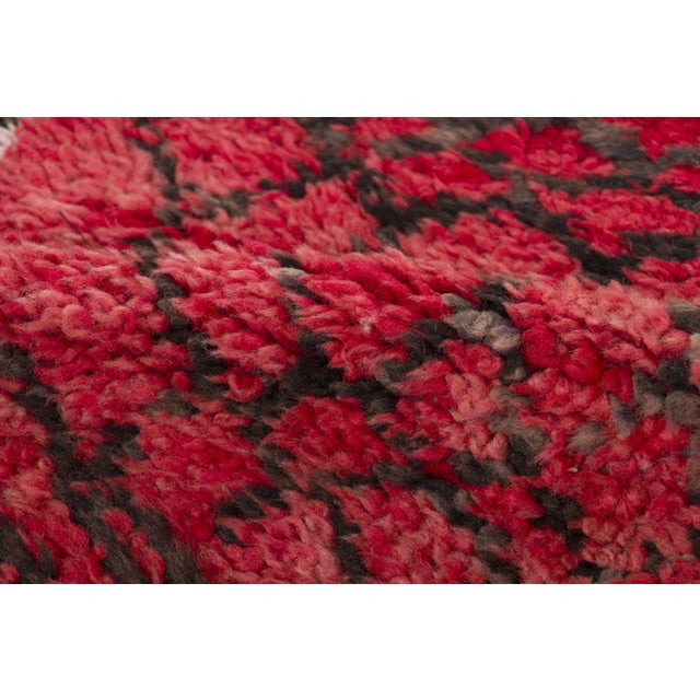 Hand-knotted in wool and originating circa 1950-1959, this 6x8 vintage Moroccan shag rug joins Rug & Kilim’s Moroccan...