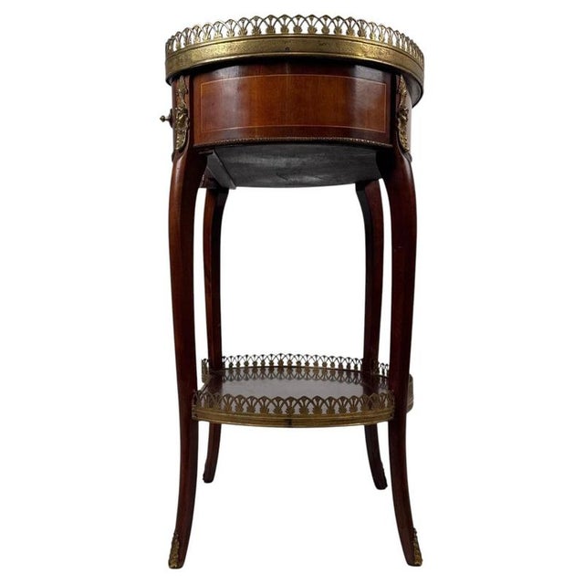An elegant early 20th-century French kidney-shaped side table, finely crafted from mahogany and distinguished by its...
