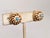 Early 1960s round goldtone cabochon faux-turquoise center with faux-pearl surround inside a spiral clip back earrings....