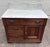 This is a stunning antique Victorian Eastlake walnut washstand, circa 1880–1900, featuring a white marble top and shaped...