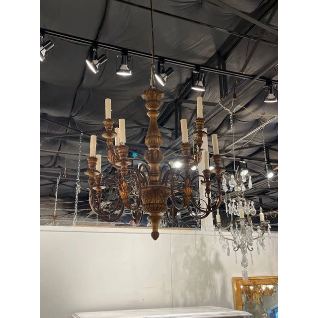 Lovely antique carved and giltwood Italian chandelier. Featuring very nice carvings along with 2 tiers of lights. Gorgeous!!