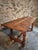 This vintage French dining table dates from 1950–1970 and is crafted entirely from solid oak. The table features a...