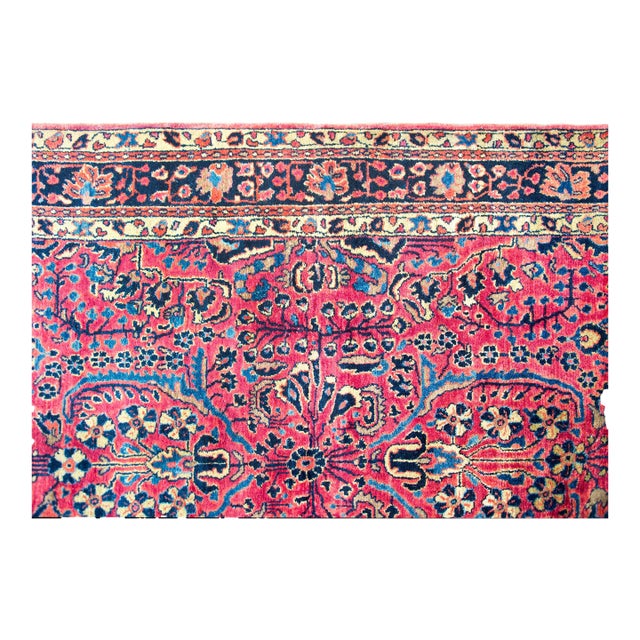 A beautiful early 20th century Persian Sarouk rug with a mirrored floral pattern with myriad stylized flowers and...