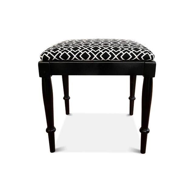 An upholstered black and white piano bench that has been fully restored. The square bench has been painted black (semi-...