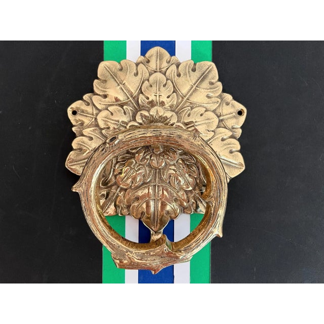 Gorgeous mid century solid polished brass door knocker in the shape of a wreath with layered dimensional leaves, central...