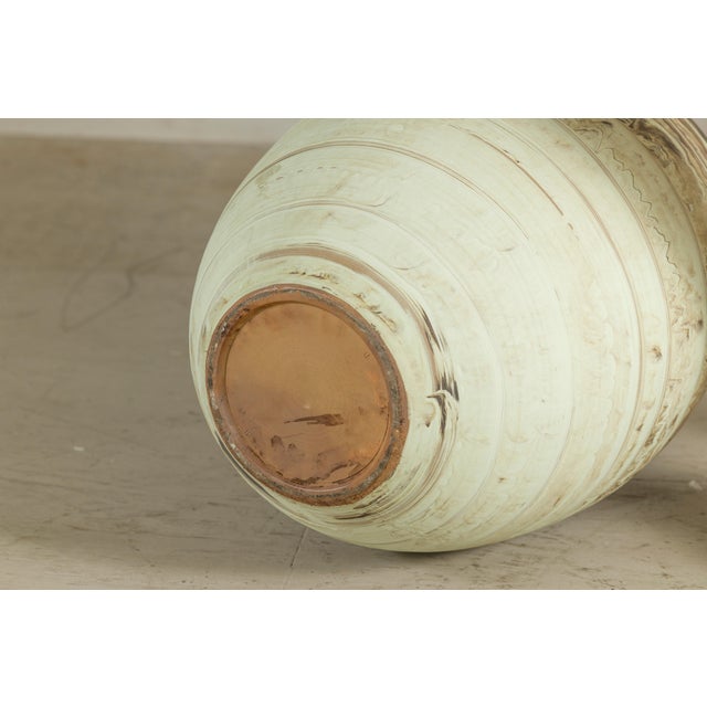 This large late 20th-century artisan ceramic vase features an ovoid form with a narrow mouth, rounded shoulders and a...