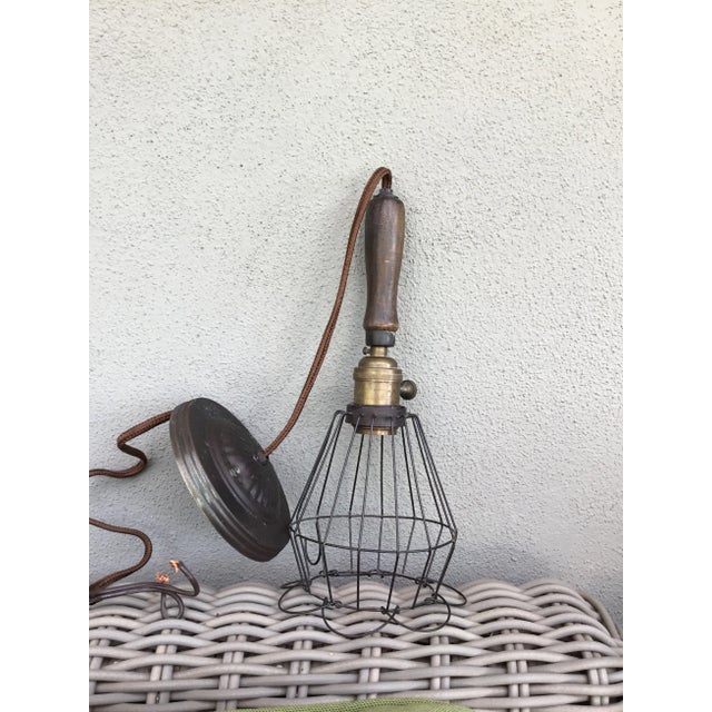 Egg basket style pendant light. Metal cage end can flare out or angle in depending on your preference. Brass socket and...