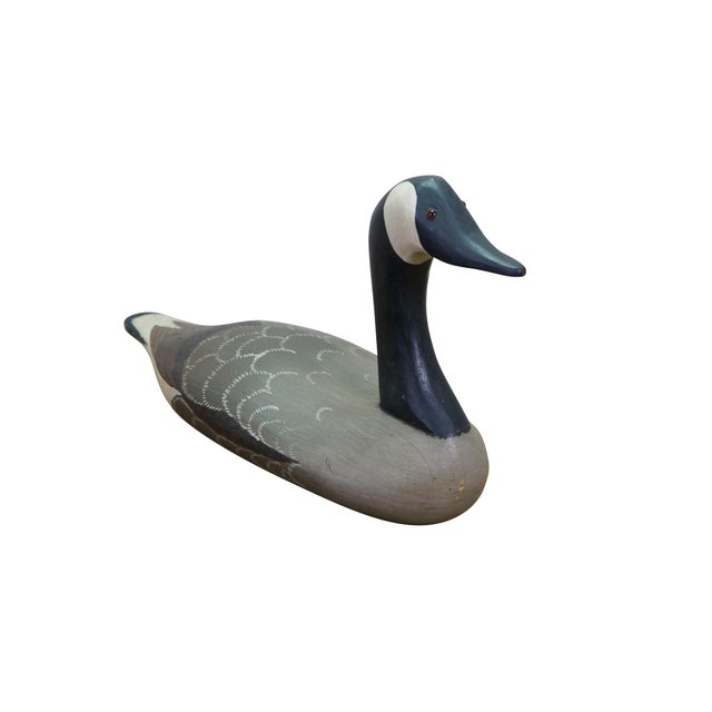 Vintage, hand-carved wooden Canada Goose decoy featuring the classic "sentinel" or upright head posture. It captures the...