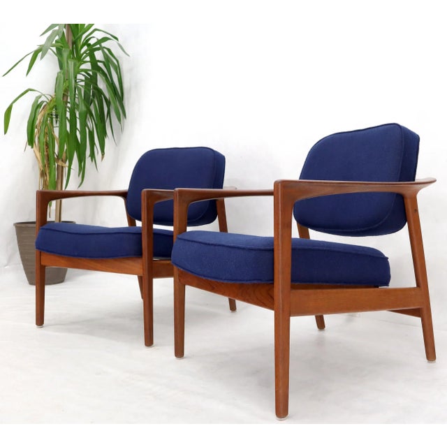 Pair of DUX Danish Modern teak lounge newly upholstery in navy blue fabric. Nice solid teak wrap around back connected...