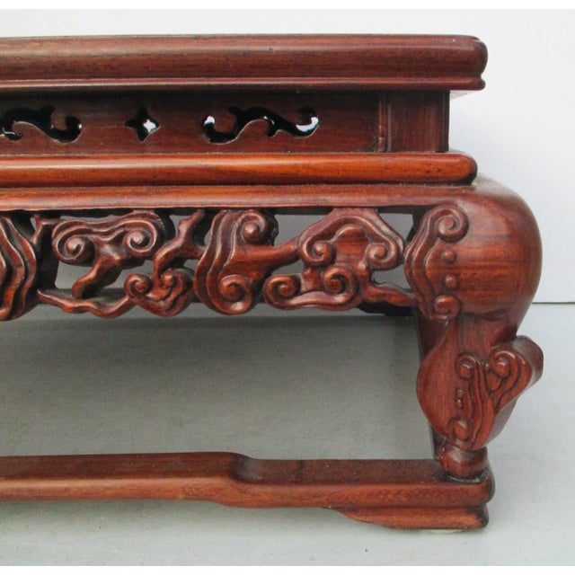Fine hardwood Chinese rectangular stand. Deeply carved apron with four corner legs with raised Chinese fret feet. The very...