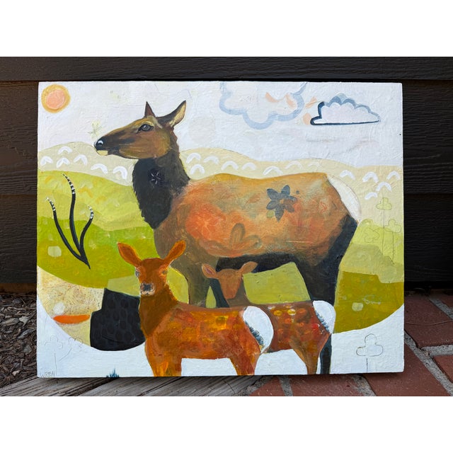 This folk art piece of a mama elk with two babies in a pastoral scene. I have witnessed a mama elk with two in Gardiner...