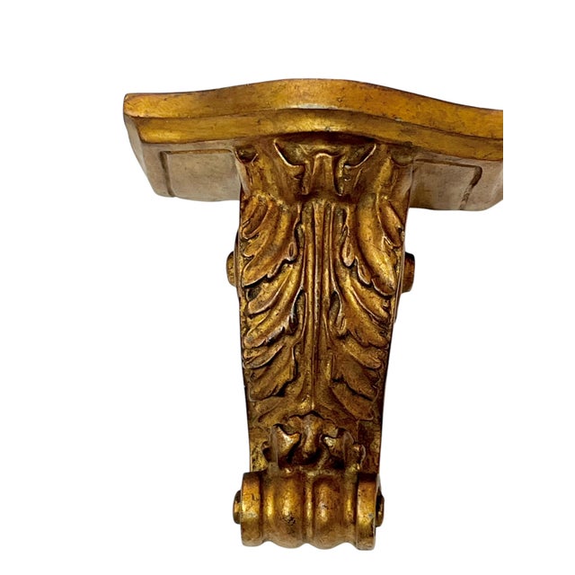 Pair of carved giltwood neoclassical style wall brackets. Original paper tag on the reverse but makers name illegible....