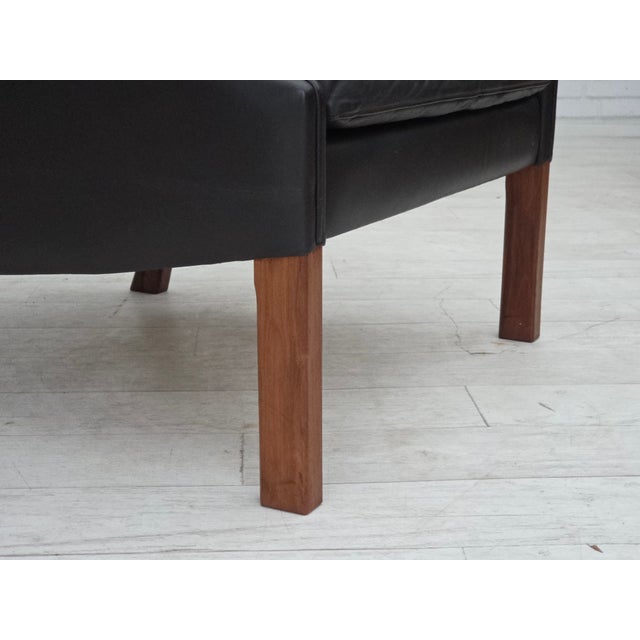 1970s, Danish design by Aage Christensen. Armchair, model “Monark“ in brown furniture leather with patina. Teak wood legs....