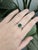 This 1.6ct Zambian emerald ring shines with an 8x6mm emerald-cut center stone, framed by natural diamond accents. Set in...