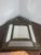 A repoussé brass framed mirror, showcasing the craftsmanship and artistry typical of the second half of the 19th century....