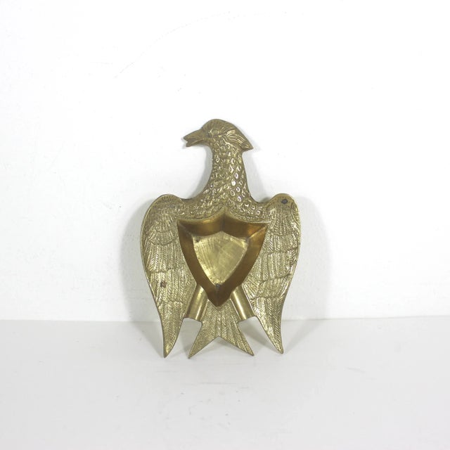 Small vintage brass ashtray or pipe tray or catchall dish in the shape of a bird or eagle. It has tiny feet. Has some nice...