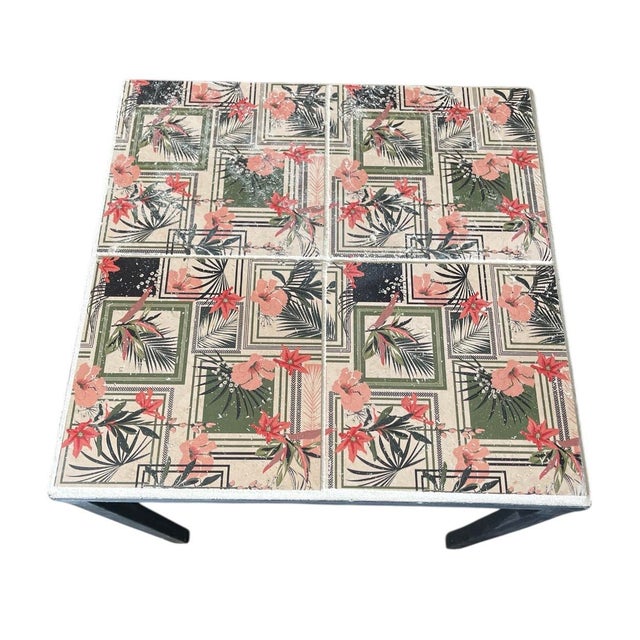 Featuring a four-tile mosaic top, the surface is adorned with a stylized tropical pattern of peach hibiscus flowers, green...