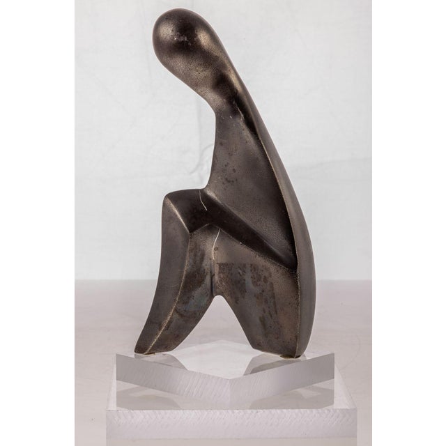 A compelling study in balance and abstraction, this modernist-style metal sculpture rests on a clear two-part acrylic...