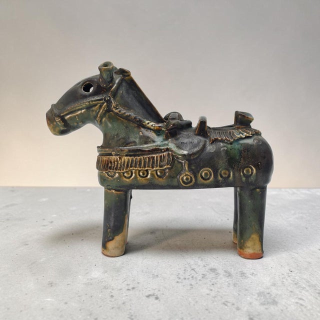 A striking vintage Chinese ceramic horse rendered in a deeply atmospheric drip glaze palette of bronze, green, and black....